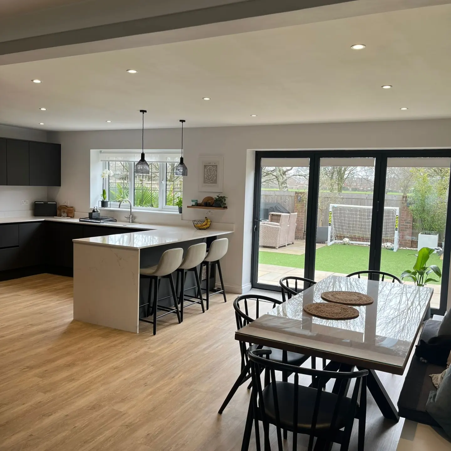 Finished open-plan kitchen extension with bi-fold doors opening onto the garden